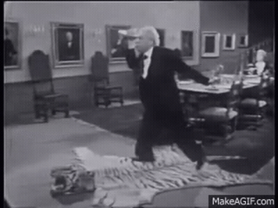 Man In Tuxedo On Tiger Skin Rug GIF