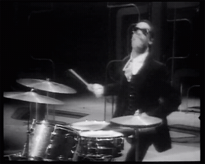Man In Tuxedo Playing Drums GIF