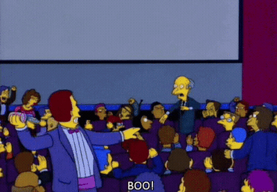 Man In Tuxedo Pointing At Crowd Saying Boo GIF