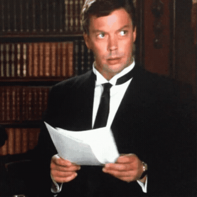 Man In Tuxedo Reading Paper GIF