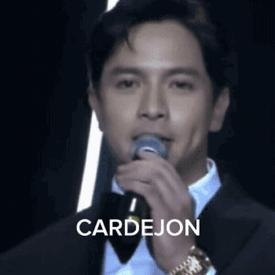 Man In Tuxedo Singing Into Microphone GIF