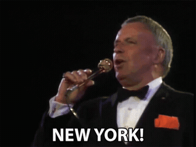 Man In Tuxedo Singing Into Microphone GIF
