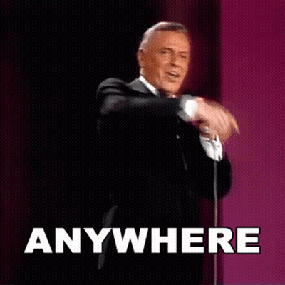 Man In Tuxedo Singing Into Microphone Saying Anywhere GIF