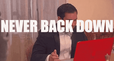 Man In Tuxedo Sitting At Laptop Never Back Down GIF