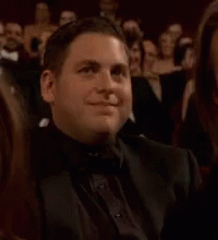 Man In Tuxedo Sitting In Crowd Clapping GIF