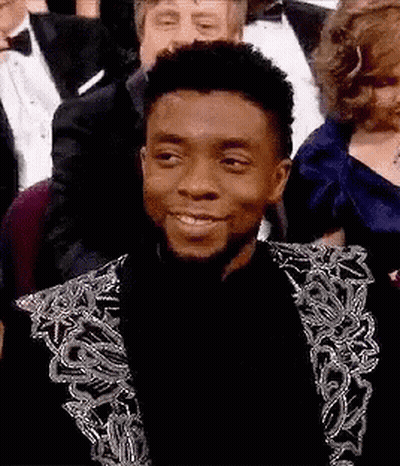 Man In Tuxedo Sitting In Crowd GIF