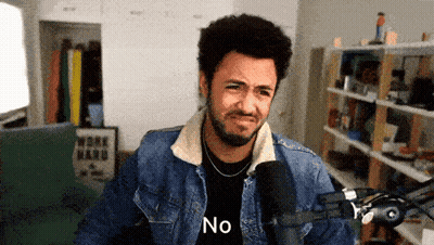 Man In Tuxedo Smiling And Looking Down GIF