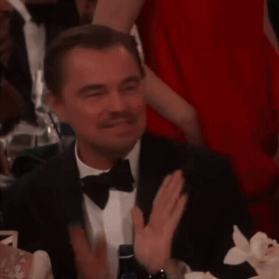 Man In Tuxedo Smiling At Table GIF