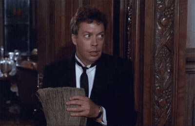 Man In Tuxedo Smiling Holding Broom GIF