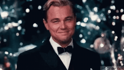 Man in Tuxedo Smiling in Front of Christmas Tree