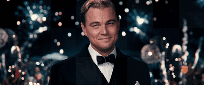 Man In Tuxedo Smiling In Front Of Crowd GIF