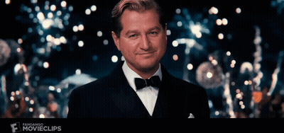 Man In Tuxedo Smiling In Front Of Fandango Movie Clip GIF