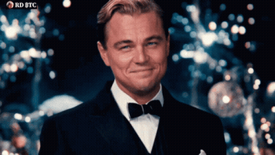 Man in Tuxedo Smiling in Front of RD BTC Banner