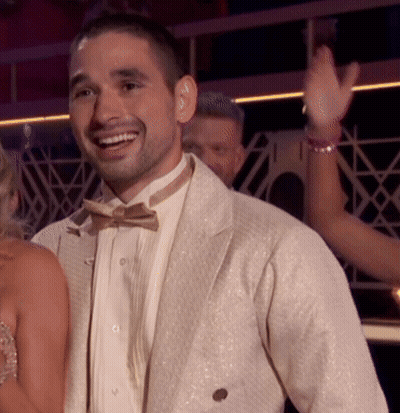 Man In Tuxedo Smiling In Front Of Woman GIF