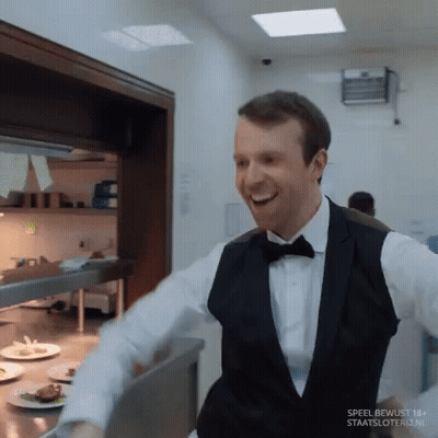 Man In Tuxedo Smiling In Kitchen Speel Bewust 18+ GIF