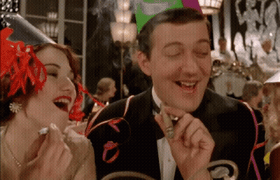 Man In Tuxedo Smoking Cigar With Laughing Woman GIF