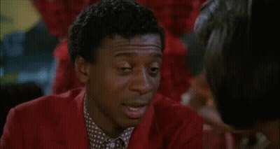 Man In Tuxedo Smoking Cigarette In Dark Room GIF
