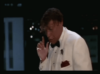 Man In Tuxedo Smoking Cigarette In Dark Room GIF