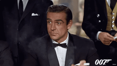 Man In Tuxedo Smoking Cigarette With 007 Logo GIF