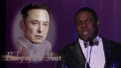 Man In Tuxedo Speaking Into Microphone Next To Elon Musk GIF