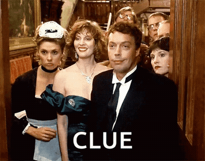Man In Tuxedo Standing Before Crowd With Clue GIF