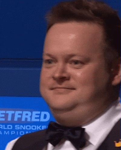 Man In Tuxedo Standing In Front Of Sign Saying Ttfred GIF