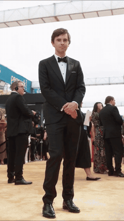 Man In Tuxedo Standing On Red Carpet GIF
