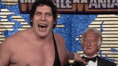 Man In Tuxedo Talking Into Microphone At World Heavyweight Wrestling Mania GIF