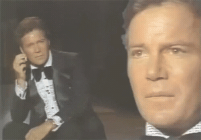 Man In Tuxedo Talking On Phone GIF