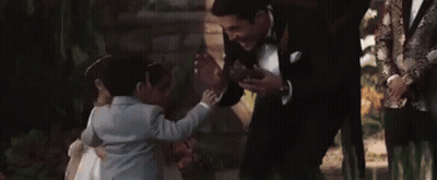 Man In Tuxedo Talking To Little Girl GIF