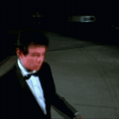 Man In Tuxedo Walking Down Street GIF