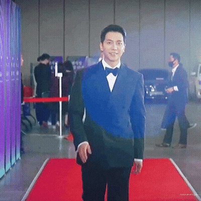 Man In Tuxedo Walking On Red Carpet GIF