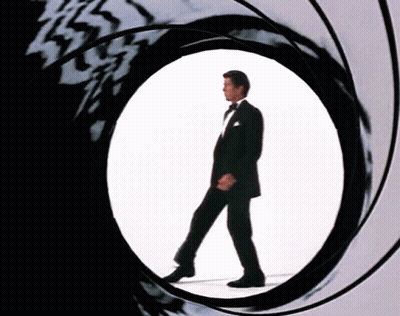 Man In Tuxedo Walking Through Circular Hole GIF