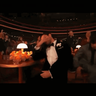 Man In Tuxedo With Bow Tie Covering Face GIF