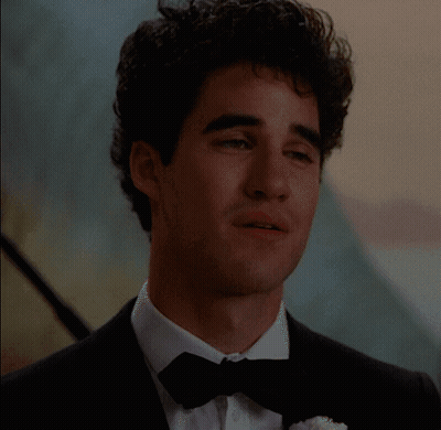 Man In Tuxedo With Bow Tie Facing Camera GIF