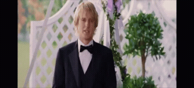 Man In Tuxedo With Bow Tie In Front Of Archway GIF