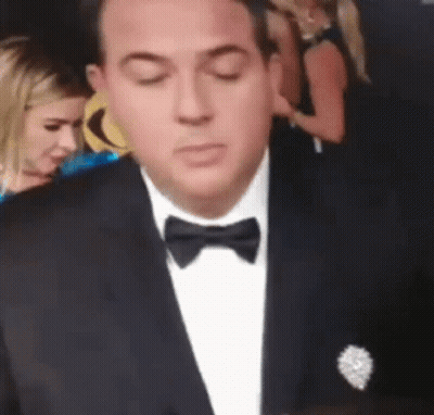 Man In Tuxedo With Bow Tie Looking Down GIF