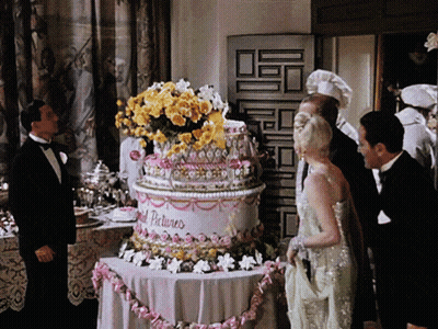 Man In Tuxedo With Cake Saying Gold Pictures GIF