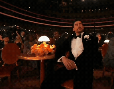 Man In Tuxedo With Hand On Face GIF