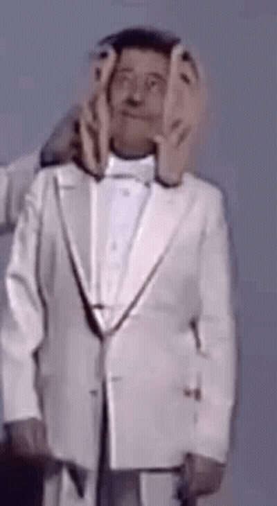 Man In Tuxedo With Hands On Face GIF