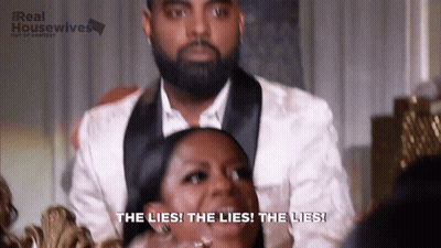 Man In Tuxedo With Laughing Woman Saying The Lies GIF