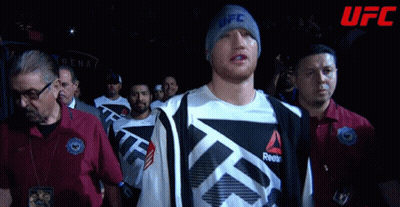 Man In UFC Beanie Walks Through Crowd GIF