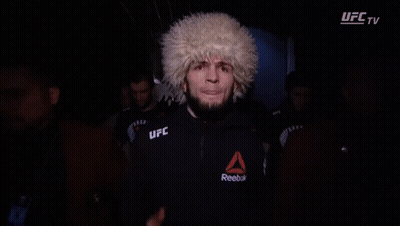 Man In UFC Glove Covers Face In Dark GIF