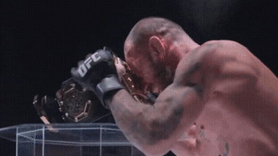 Man In UFC Glove Holding Trophy GIF