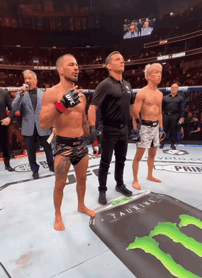 Man In UFC Glove In Front Of Monster Energy Sign GIF