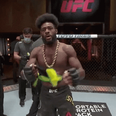 Man In UFC Ring Holding Banana GIF