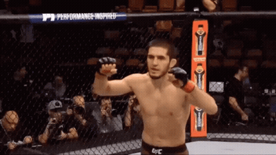 Man In UFC Ring In Front Of Performance Inspired Banner GIF