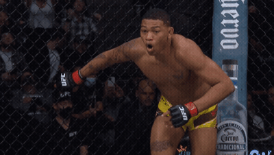 Man In UFC Shorts In Front Of Fence GIF