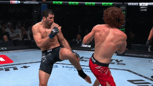 Man In UFC Shorts Kicking Another Man In Cage GIF