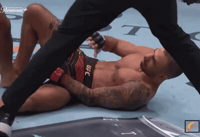 Man In UFC Shorts Laying On Floor GIF